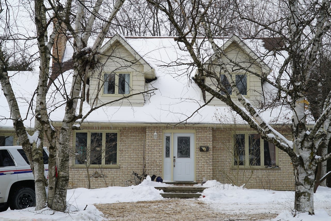 default-234 A beige house covered with snow on the ground